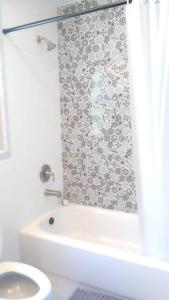 a bathroom with a toilet and a shower curtain at #3 Howling Wolf's Lair - Cabin W/Fireplace & Views in Santa Ysabel +13 photos