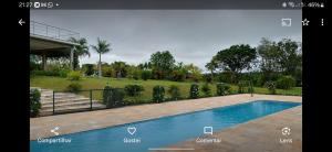 a picture of a swimming pool in a yard at Sítio Santa Cecília in Itapetininga
