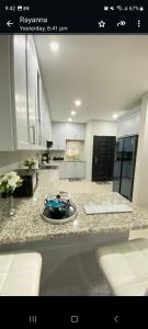 a kitchen with a counter with a plate on it at Serenity Condo in Piarco