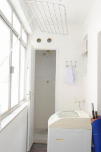 a white bathroom with a sink and a window at Refúgio pra sua família in Guarapari +26 photos