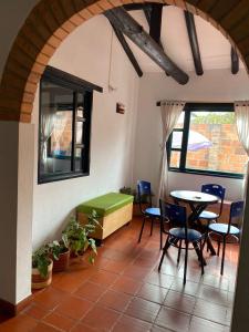 a room with a table and chairs and a table and a table at Casa Villa Ramos in Villa de Leyva