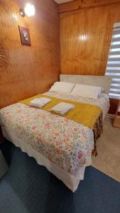 a bedroom with two beds in a room at Depto. Altos de Tenglo in Puerto Montt