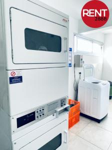 a kitchen with a microwave oven and a room at Rent Balbin in Buenos Aires