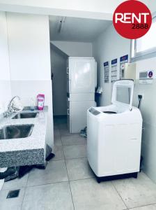 a kitchen with a sink and a washing machine at Rent Balbin in Buenos Aires