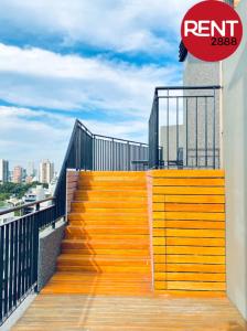a yellow stairway with a sign on a building at Rent Balbin in Buenos Aires