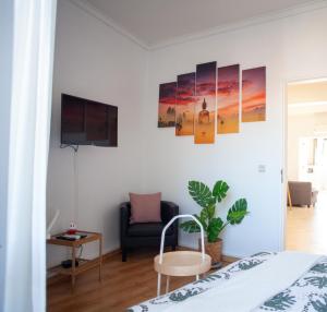 a bedroom with a bed and a tv on a wall at Just4u Apartment 2 in Almada