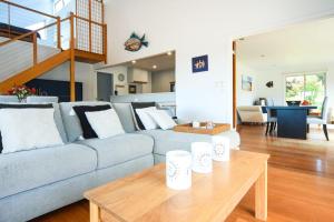 a living room with a couch and a table at Summerwood in Flinders +29 photos