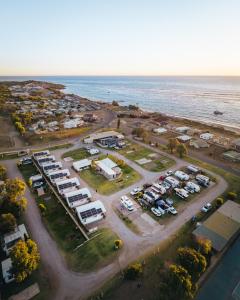 an aerial view of a parking lot next to the ocean at Horrocks Beach Caravan Park in Horrocks