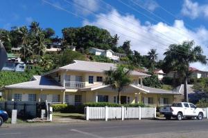 a white truck parked in front of a house at New Mavida Lodge in Levuka