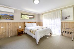 a bedroom with a large bed and a window at The Crays Accommodation in Strahan