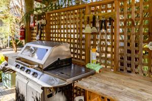 a kitchen with a grill and a table with wine bottles at The Crays Accommodation in Strahan