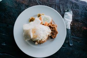 a white plate of food on a table at Padi Bali Jatiluwih by Manara in Jatiluwih