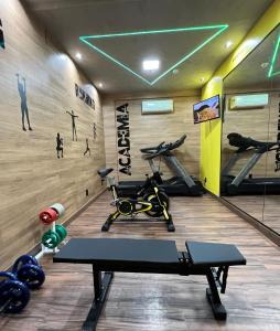 a gym with a treadmill and a bike in a room at Play Hotel Águas Claras in Taguatinga