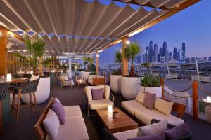 a rooftop restaurant with a view of the city at Marriott Resort Palm Jumeirah, Dubai in Dubai