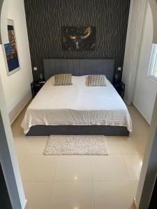 a bedroom with a bed with a white comforter at Villa Marion in San Fulgencio