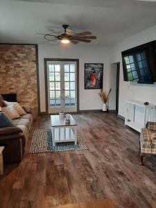 a living room with a couch and a coffee table at Country Haven-Dog Friendly, 6 bed 3 bath Farmhouse, Jacuzzi Tub, Firepit, Games, Large private yard! in South Haven