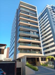 a large apartment building with two tall buildings at Apartamento novo, perto da praia e conveniências in Salvador