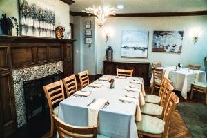 a dining room with tables and chairs and a chandelier at Cameron Estate Inn in Mount Joy