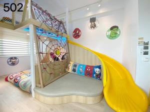 a childs play room with a slide at Wind Natural Parent-child Inn in Houli