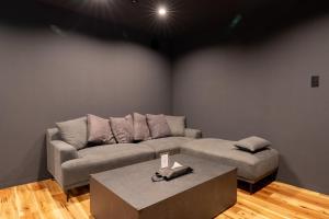 a living room with a couch and a table at THE SECOND Nasukogen Forest House in Nasu-yumoto