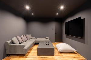 a living room with a couch and a tv at THE SECOND Nasukogen Forest House in Nasu-yumoto