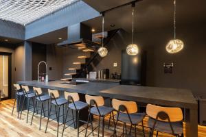a large black bar with chairs and a counter at THE SECOND Nasukogen Forest House in Nasu-yumoto +118 photos