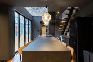 a long dining room with a long table and chairs at THE SECOND Nasukogen Forest House in Nasu-yumoto