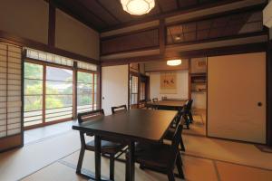 a dining room with a table and chairs at 古民家一棟貸 太田邸 in Yazu