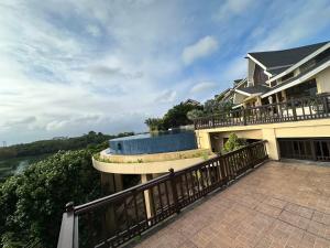 a house with a balcony with a swimming pool at Alta Vista De Boracay Hymettus 109 in Boracay