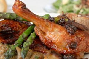 a plate of food with meat and asparagus at Cameron Estate Inn in Mount Joy