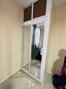 a glass door in a room with a mirror at Villa Richie's House RD. 