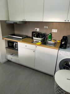 a small kitchen with a sink and a microwave at Smart Appart in Cologne