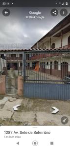 uma imagem de um edifício com uma cerca em Kitnet em Matinhos PR Balneário Riviera em Matinhos