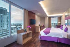 Ένα ή περισσότερα κρεβάτια σε δωμάτιο στο Quest Hotel Darmo - Surabaya by ASTON
