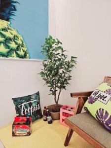 a living room with a potted plant and a chair at Sosaewool Avenue in Bucheon