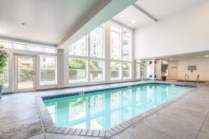 a swimming pool in a building with windows at Seattle Among The Trees: in Belltown w/Parking! in Seattle