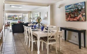 a dining room with a white table and chairs at Waterfront 2-bed townhouse - Harbour 17 townhouse in Gros Islet