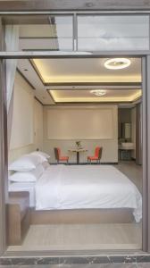 a bedroom with a bed and a table with chairs at Guilin Meishe Homestay in Guilin