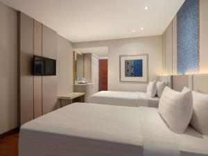 Postel nebo postele na pokoji v ubytování Hotel Santika Premiere Gubeng Surabaya