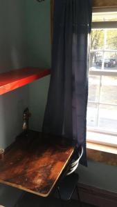 a wooden bench in a room with a window at Rock Pad AirBnB in New Haven