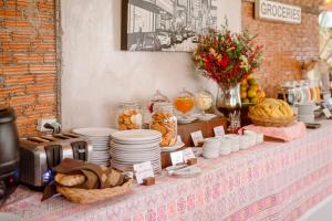 a table with plates and bowls of food on it at Farmstay at Pai in Pai