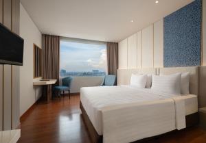 Postel nebo postele na pokoji v ubytování Hotel Santika Premiere Gubeng Surabaya