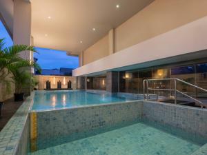 an indoor swimming pool in a house at Hotel Santika Premiere Gubeng Surabaya in Surabaya