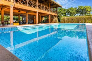 a swimming pool in front of a house at Casitas de madera in Punta Chame