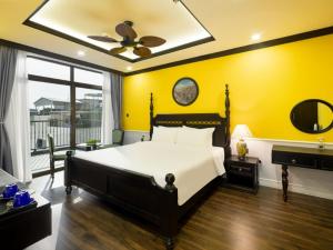 a bedroom with a large bed and a ceiling fan at Charming beauty hotel in Da Nang