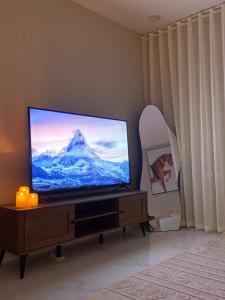 a flat screen tv sitting on a stand in a living room at الرياض حي العقيق in Riyadh