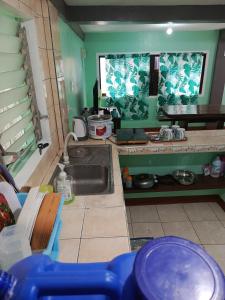 a kitchen with a sink and a counter top at Baloy beach house in Olongapo