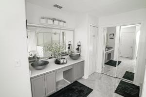 a bathroom with two sinks and a mirror at Magical Vacation Stay in Davenport +34 photos
