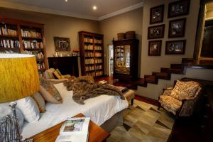a living room with a bed and a staircase at The Great Gatsby Houghton in Johannesburg