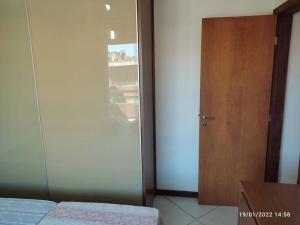 sypialnia z przesuwnymi szklanymi drzwiami i łóżkiem w obiekcie Apartamento encantador a 250 m da Praia do Forte w mieście Cabo Frio